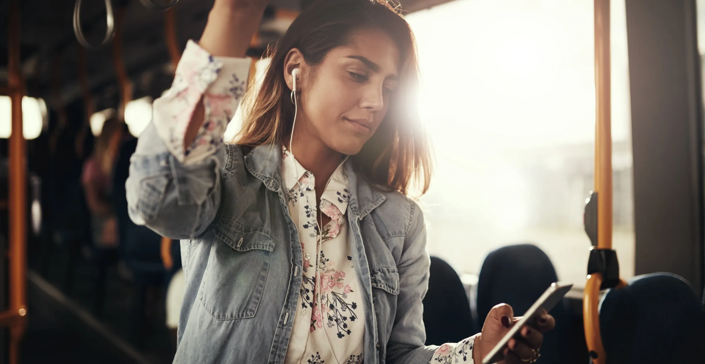 city woman checking her phone while riding the bus